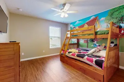a bedroom with a bunk bed and a ceiling at 8033 Acadia Estates Court in Orlando
