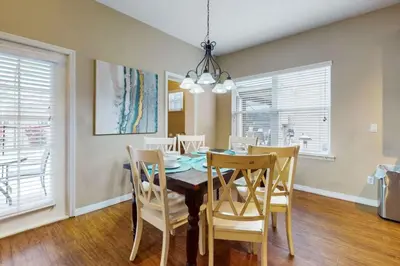 a dining room with a table and chairs at 8033 Acadia Estates Court in Orlando