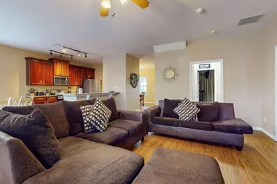 a living room with two couches and a kitchen at 8033 Acadia Estates Court in Orlando