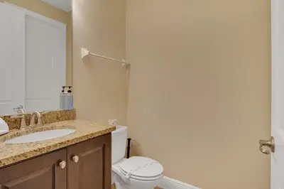 a bathroom with a white toilet and a sink at 480 Lasso Dr. · 480 Villa - Large Luxury 7BD Home - SpaPool in Orlando