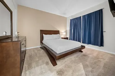 a bedroom with a bed and a dresser and a window at Cozy Villa 08 BedroomsPoolGame Room in Kissimmee