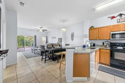 a kitchen and dining room with a dining table at Family Escape! HotTub+Grill+Disney! in Kissimmee