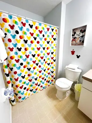a bathroom with a shower curtain with a toilet at Hot Tub, BBQ - Near Disney Fun! in Kissimmee