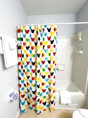 a bathroom with a shower curtain with hearts at Hot Tub, BBQ - Near Disney Fun! in Kissimmee