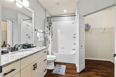 a bathroom with a sink and a toilet and a shower at Luxury 4BR Resort Villa @ Lucaya Village in Kissimmee