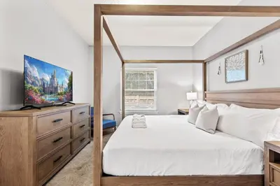a bedroom with a bed and a television on a dresser at Luxury 4BR Resort Villa @ Lucaya Village in Kissimmee