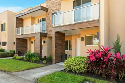 a house with plants in front of it at Two Story Resort Retreat Near Theme Parks in Orlando