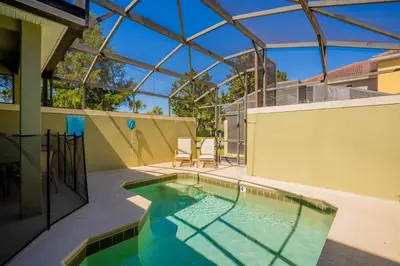 a swimming pool in a house with a glass ceiling at Paradise Found: Private 5-Bed Townhouse Oasis in Kissimmee