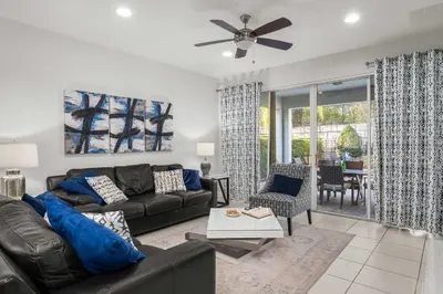 a living room with a couch and a table at Private Heated Pool Game room 6MI to Disney in Orlando