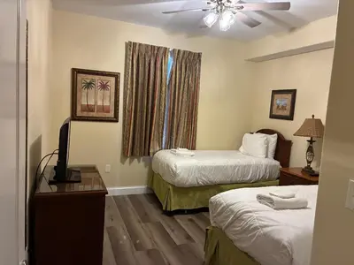 a hotel room with two beds and a window at Blue Heron Beach Resort Tower 12 FL 1204 Fully Furnished in Orlando