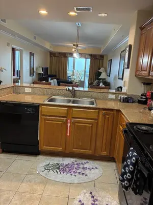 a kitchen with a sink and a stove at Blue Heron Beach Resort Tower 12 FL 1204 Fully Furnished in Orlando