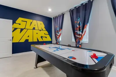 a pool table in a room with a star wars sign at Your Beautiful Hideaway 9-Bedroom Luxury Villa in Kissimmee
