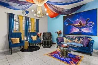 a living room with a couch and a table at Themed Villa with Private Pool Games Massage Chair in Kissimmee