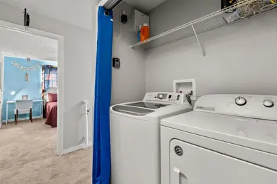 a laundry room with a washer and dryer at Themed Villa with Private Pool Games Massage Chair in Kissimmee