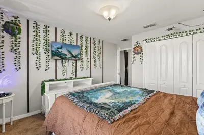 a bedroom with a large bed in a room at Themed Villa with Private Pool Games Massage Chair in Kissimmee