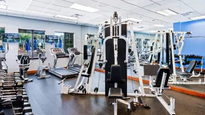 a gym with cardio equipment and tread machines at Themed Villa with Private Pool Games Massage Chair in Kissimmee