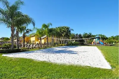 a volley ball net in a park with a playground at Themed Villa with Private Pool Games Massage Chair in Kissimmee