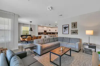 a living room with a couch and a table at Casa 6Q c/ Piscina & Sala de Jogos — Storey Lake in Kissimmee