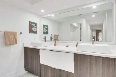 a bathroom with two sinks and a large mirror at Spacious 4BR,3BA Home Near Disney in Kissimmee