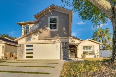 a house with a white garage at Spacious 4BR,3BA Home Near Disney in Kissimmee