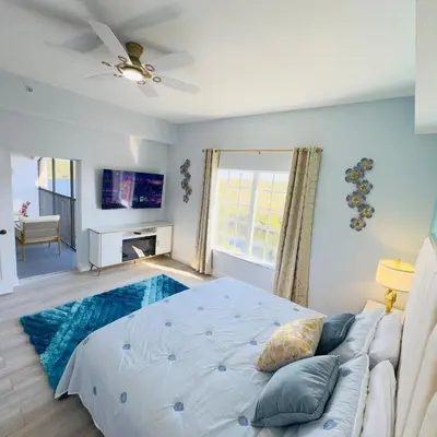 a bedroom with a bed and a couch and a window at Your Epic Disney Getaway Spacious Home 3BD 3BA in Orlando