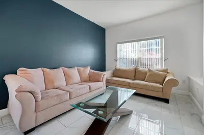 a living room with a couch and a glass table at Famous 5 Star Home in Kissimmee with Game Room in Kissimmee