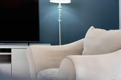 a living room with a white couch and a television at Famous 5 Star Home in Kissimmee with Game Room in Kissimmee