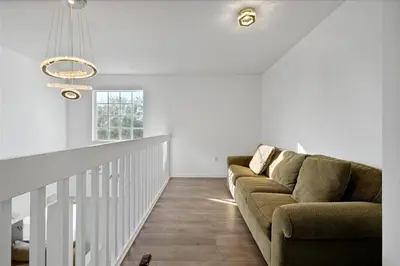 a living room with a couch and a staircase at Famous 5 Star Home in Kissimmee with Game Room in Kissimmee