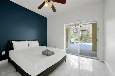 a bedroom with a bed and a ceiling fan at Famous 5 Star Home in Kissimmee with Game Room in Kissimmee