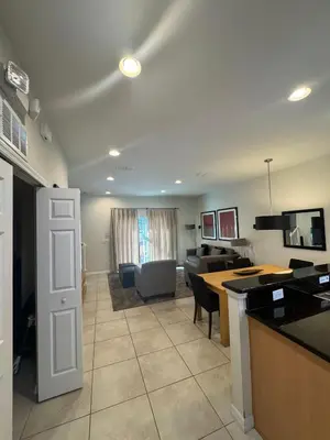 a kitchen and living room with a table and chairs at Cosy Family Home in encantada kissimee in Kissimmee
