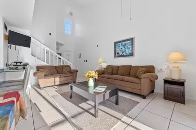 a living room with two couches and a coffee table at Mango Keys Getaway Near Theme Parks in Kissimmee
