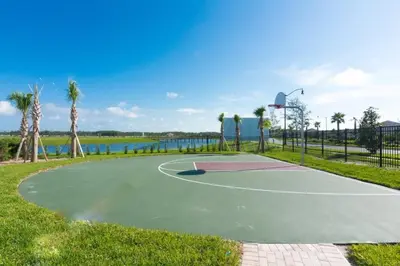a basketball court in a park next to the water at Casa c/ 4Q no Storey Lake Resort c/ Piscina in Kissimmee