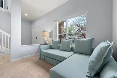 a living room with a couch and a window at Water View Pool Home Near Disney in Kissimmee