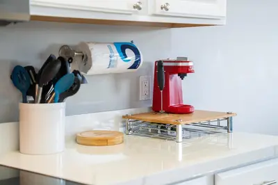 a red mixer sitting on a rack on a kitchen counter at Water View Pool Home Near Disney in Kissimmee
