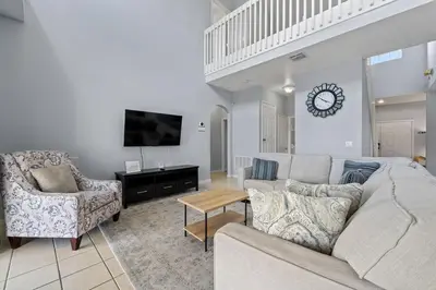 a living room with a couch and two chairs at Water View Pool Home Near Disney in Kissimmee