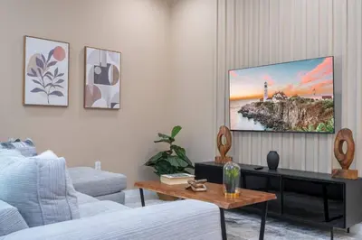 a living room with a tv on a wall at 7547 NEW 5 minutes from Disney 5BD 5BH 15P in Orlando