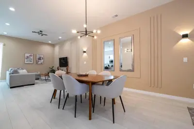 a dining room with a table and chairs at 7547 NEW 5 minutes from Disney 5BD 5BH 15P in Orlando