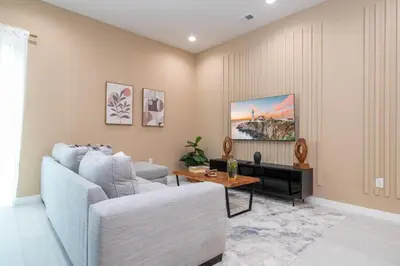 a living room with a couch and a table at 7547 NEW 5 minutes from Disney 5BD 5BH 15P in Orlando