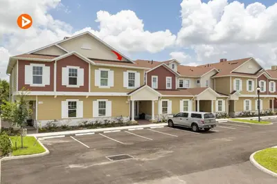 aominium building with a car parked in a parking lot at 7547 NEW 5 minutes from Disney 5BD 5BH 15P in Orlando