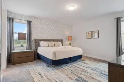 a bedroom with a large bed and a window at 381 Fantastic Home Near Disney 5BD 5BT 14P in Orlando
