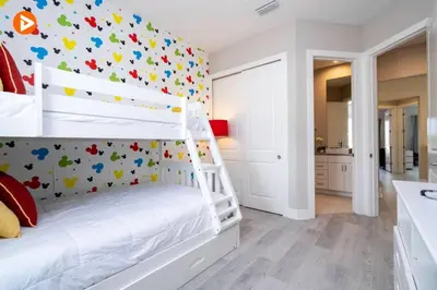 a bedroom with a white bunk bed with a wall covered in butterflies at Perfect Home 5 Minutes from Disney 5BD 15P in Orlando