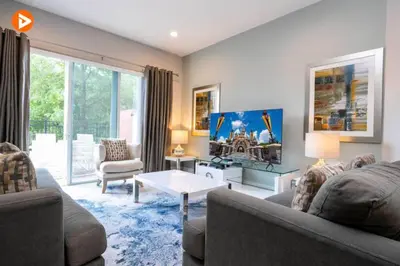 a living room with a couch and a table at Perfect Home 5 Minutes from Disney 5BD 15P in Orlando