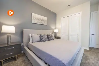 a bedroom with a bed and a dresser with a lamp at (7556) 3-Bedroom House in Resort near Disney in Orlando
