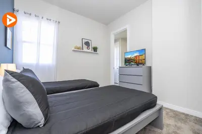 a bedroom with a bed and a television in it at (7556) 3-Bedroom House in Resort near Disney in Orlando
