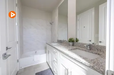 a white bathroom with a sink and a tub and a mirror at (7556) 3-Bedroom House in Resort near Disney in Orlando