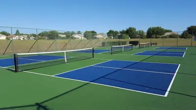 a group of tennis courts on a tennis court at 20 mins Disney, Private Heated Pool & Spa, Games Room, Spacious, Good for Groups in Orlando