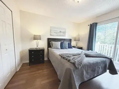 a bedroom with a bed with blue pillows and a window at The Family Den in Kissimmee