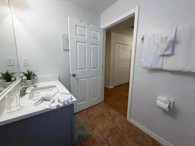 a bathroom with a sink and a mirror at The Family Den in Kissimmee