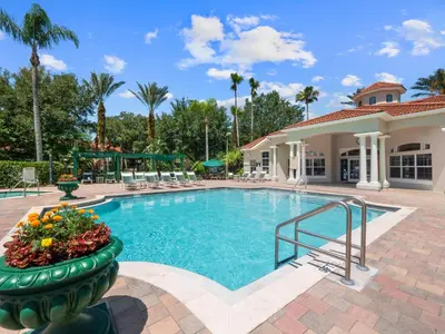a swimming pool at a resort with a building at The Family Den in Kissimmee