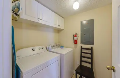 a small laundry room with a washer and dryer at Sun Key Getaway in Kissimmee